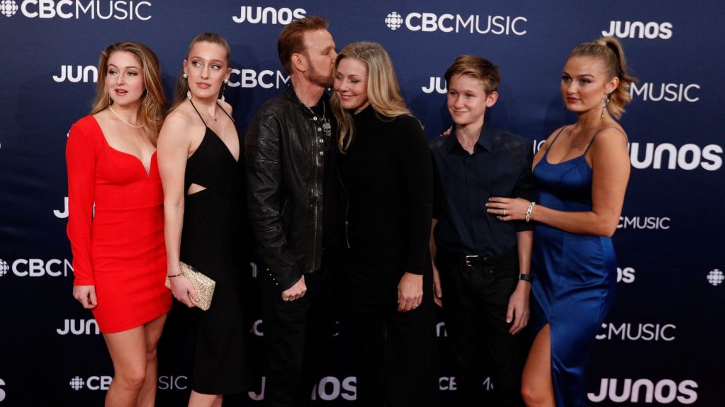 A photo of Corey hart, Julie Masse and their four children.