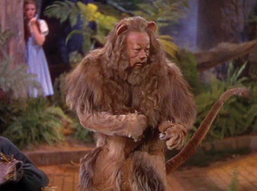 Photo of Bert Lahr wearing the heavy costume made out of real lion fur.