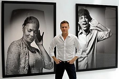Bryan Adams with some of the photographic portraits he has taken in his role as photographer.