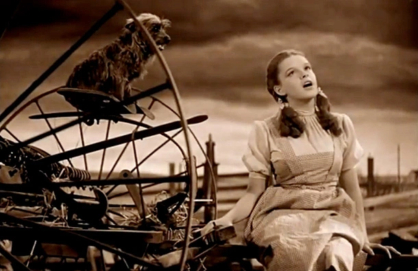Sepia-toned photo of Judy Garland, as Dorothy, singing "Over the Rainbow".