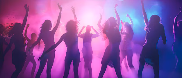 People dancing joyfully in a club or bar.